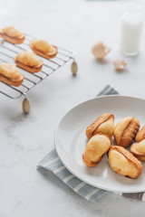 Homemade madeleine on mable background. 