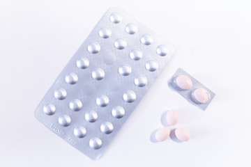 packing and pills on white background