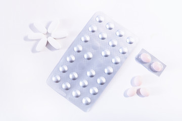 packing and pills on white background