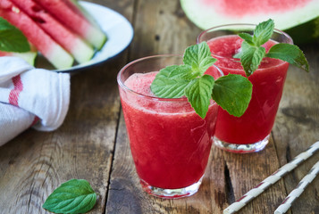 Watermelon smoothies with mint on a wooden table