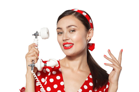 Portrait of beautiful young woman with phone, dressed in pin-up style.