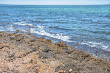 Coast of mediterranean sea with the sky and waves.