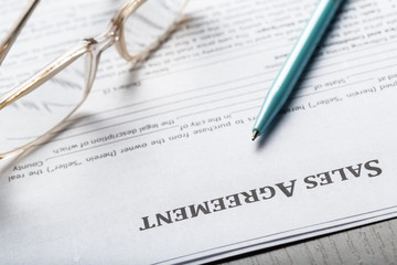 Close up shot of Eyeglasses  on contract document papers business concept