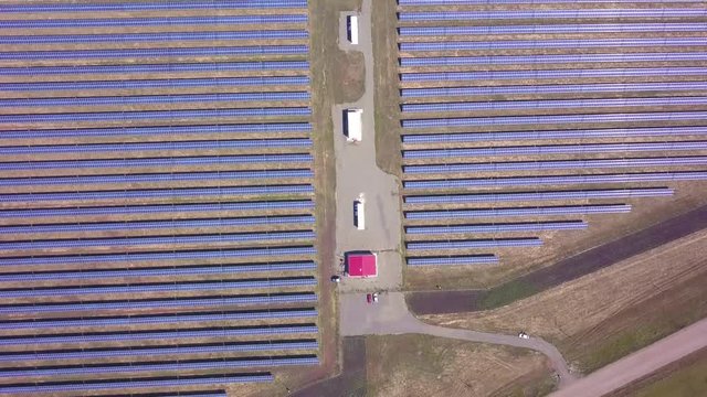 Aerial lateral motion view on solar power plant, beautiful countryside landscape, clean energy panels.
