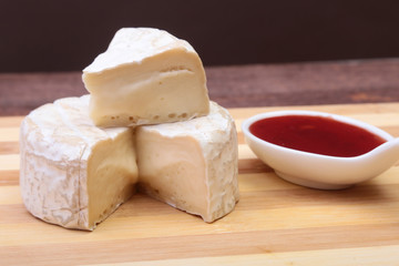 Cheese with white mold. Camembert or brie type with Cranberry sauce.. Healthy breakfast.
