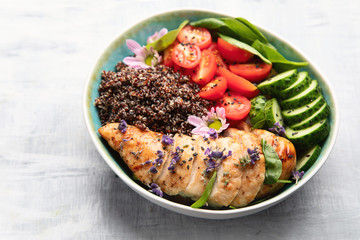 Healthy bowl with roasted chicken and quinoa.