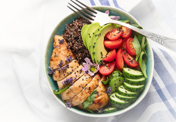 Healthy bowl with roasted chicken and quinoa.