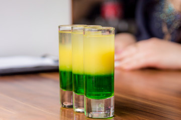 Beautiful tricolor cocktail. three-color cocktail in the bar