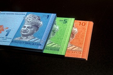 Malaysia Currency (MYR): Stack of Ringgit Malaysia bank note. There are one, five and ten Ringgit Malaysia