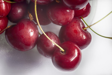 Group of tasty red cherries on white background