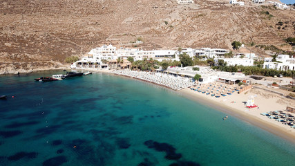 Aerial drone photo of famous turquoise clear water beach of Psarou in iconic island of Mykonos, Cyclades, Greece