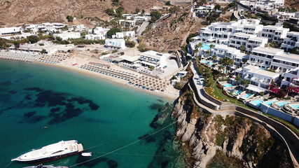 Obraz premium Aerial drone photo of famous turquoise clear water beach of Psarou in iconic island of Mykonos, Cyclades, Greece