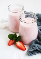 Jars with strawberry yogurt