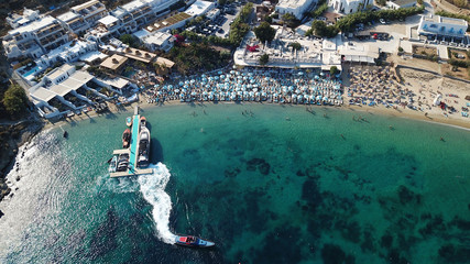Aerial drone photo of famous turquoise clear water beach of Psarou in iconic island of Mykonos,...