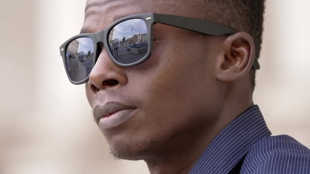 Confident succesful black man take off sunglasses and staring at camera