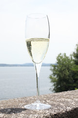 glass with champagne wine on a stone handrail