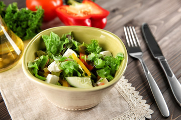 Bowl with fresh vegetable salad on table. Diet food
