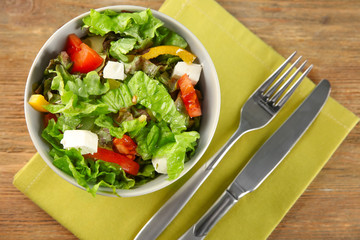 Bowl with fresh vegetable salad on table. Diet food