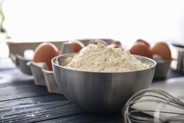 Bowl with flour on kitchen table. Bakery workshop