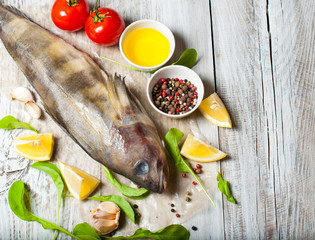 Fish and seafood on a wooden, light background, cooking food, a menu for a restaurant or a cafe.