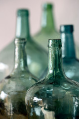Green glass carafes on white background.