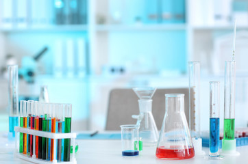 Glassware with different samples on table in laboratory