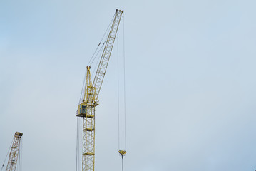 Crane on cloudy background. Building concept