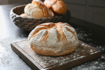 Fresh tasty bread on wooden board