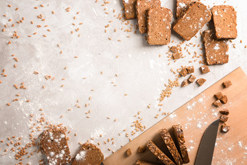 Flat lay composition with slices of freshly baked rye bread on gray background