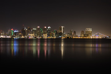 Horizontal Night Skyline of San Diego with lighted bridge, buildings and reflections