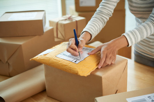 Woman writing shipping address