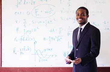 African foreign teacher teaching  science in the classroom.