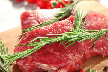 Fresh raw meat with rosemary, closeup