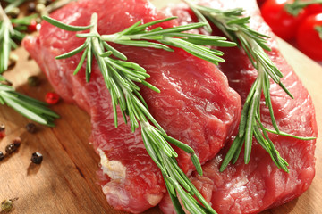 Fresh raw meat with rosemary, closeup