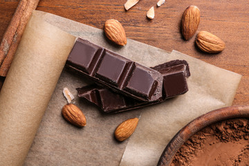 Delicious chocolate with almonds on table