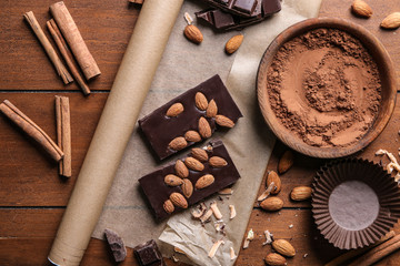 Delicious chocolate with almonds on table
