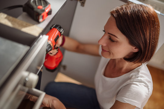 Woman working on a new kitchen installation