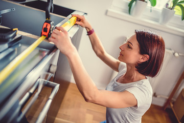 Woman using leveling tool