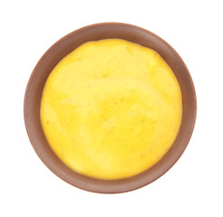 Bowl with curry sauce on white background, top view