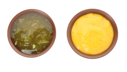 Bowls with different sauces on white background, top view