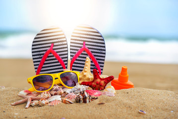 Slates, sunglasses and seashells on the background of the sea.