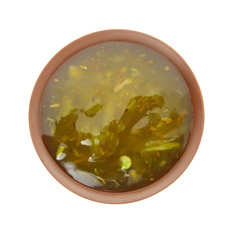 Bowl with pesto sauce on white background, top view