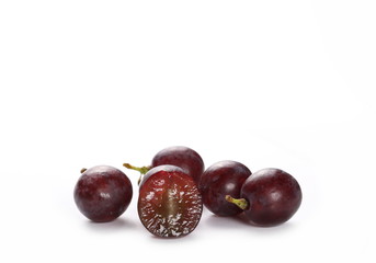 Cardinal grapes with halved slice isolated on white background