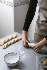 Woman on the home kitchen prepares the dough with flour to make organic pan, bread or pasta