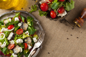 A delicious salad with sardines and feta cheese.