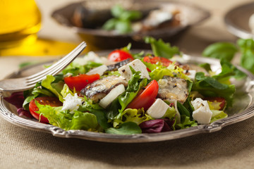 A delicious salad with sardines and feta cheese.