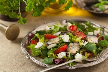 A delicious salad with sardines and feta cheese.