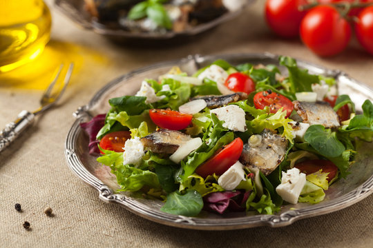 A delicious salad with sardines and feta cheese.