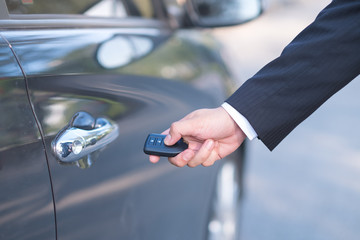 Man in formalwear open car door, Hand on car door handle