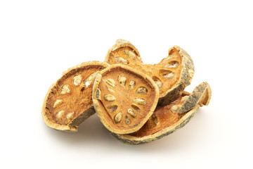 pile of dried bael fruit on white background